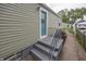 Charming home exterior with updated siding, a blue front door, and a concrete porch with railings at 4933 W 13Th W St, Speedway, IN 46224