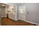 Bright kitchen featuring white cabinets, stainless steel appliances, and wood flooring at 4933 W 13Th W St, Speedway, IN 46224