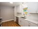 Modern kitchen featuring white cabinets, stainless steel appliances, and bright white backsplash at 4933 W 13Th W St, Speedway, IN 46224