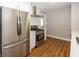 Updated kitchen with stainless steel refrigerator, modern appliances, and bright white backsplash at 4933 W 13Th W St, Speedway, IN 46224