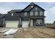 New two-story home with gray siding, brick accents, and an attached two car garage at 4988 Elaine Ct, Noblesville, IN 46062