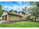 Spacious backyard featuring a stone facade, deck, and well-maintained lawn, perfect for outdoor living at 4990 E County Road 750 S, Brownsburg, IN 46112
