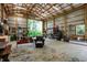 A spacious barn boasts concrete flooring, a wooden beam ceiling, and ample storage and workspace at 4990 E County Road 750 S, Brownsburg, IN 46112