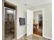 Bathroom with a glass shower and an open door leading to a room with a dining table and chairs at 4990 E County Road 750 S, Brownsburg, IN 46112