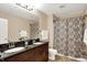 Bathroom with double sink vanity and shower with patterned curtain at 4990 E County Road 750 S, Brownsburg, IN 46112