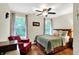 Bedroom with natural light, ceiling fan, hardwood floors and a red leather chair at 4990 E County Road 750 S, Brownsburg, IN 46112