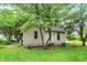 Charming cottage featuring simple architecture, nestled among trees, and a well maintained lawn at 4990 E County Road 750 S, Brownsburg, IN 46112