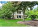 Beautiful two-story home featuring a unique stone facade and lush, mature trees in a serene setting at 4990 E County Road 750 S, Brownsburg, IN 46112