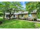 Charming stone home with lush landscaping, a well-manicured lawn, and a welcoming front entrance at 4990 E County Road 750 S, Brownsburg, IN 46112