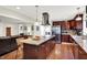 Modern kitchen featuring an island, stainless steel appliances, and cherry wood cabinets at 4990 E County Road 750 S, Brownsburg, IN 46112