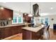 Modern kitchen with cherry wood cabinetry, granite countertops, and stainless steel appliances at 4990 E County Road 750 S, Brownsburg, IN 46112