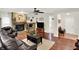 Inviting living room featuring a stone fireplace, hardwood floors, and comfortable seating at 4990 E County Road 750 S, Brownsburg, IN 46112