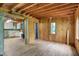 Spacious living room with wood paneled walls and hardwood floors, adjacent to a kitchen area at 4990 E County Road 750 S, Brownsburg, IN 46112
