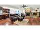 Spacious living room with hardwood floors, a stone fireplace, and open access to the kitchen at 4990 E County Road 750 S, Brownsburg, IN 46112
