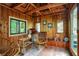 Cozy sunroom with wood paneled walls, hardwood floor and rattan furniture, with natural light pouring in at 4990 E County Road 750 S, Brownsburg, IN 46112