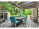 Covered outdoor seating area with a table and chairs, offering a relaxing view of lush greenery at 4990 E County Road 750 S, Brownsburg, IN 46112