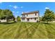 Large backyard with green grass and mature trees, providing a serene outdoor space for relaxation and enjoyment at 515 Lynton Way, Westfield, IN 46074