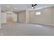 A finished basement featuring plush gray carpet, ceiling fan, recessed lighting, and potential for various uses at 515 Lynton Way, Westfield, IN 46074