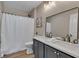Bathroom featuring a double sink vanity with a large mirror and a shower with a curtain at 515 Lynton Way, Westfield, IN 46074