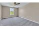 Spacious carpeted bedroom featuring a lighted ceiling fan and a bright window at 515 Lynton Way, Westfield, IN 46074
