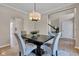 Dining area features a modern table, four chairs, a stylish light fixture, and neutral wall color at 515 Lynton Way, Westfield, IN 46074