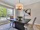 Cozy dining room with modern light fixture, stylish table, and large window with a neighborhood view at 515 Lynton Way, Westfield, IN 46074
