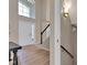 Bright foyer featuring a high ceiling, large front window, and elegant staircase with wood floors at 515 Lynton Way, Westfield, IN 46074