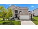 Attractive two-story home boasting a brick facade, well-manicured lawn, and attached garage at 515 Lynton Way, Westfield, IN 46074
