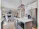 Stylish kitchen featuring a gray island with quartz countertop, modern lighting, and stainless steel refrigerator at 515 Lynton Way, Westfield, IN 46074