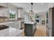 Open concept kitchen with stainless steel appliances, gray island, and seamless flow into the living room at 515 Lynton Way, Westfield, IN 46074