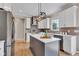 Bright kitchen features stainless steel appliances, a center island with a quartz countertop, and white cabinets at 515 Lynton Way, Westfield, IN 46074