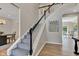 Elegant staircase with carpeted steps, dark wood accents, and hardwood flooring in the foyer at 515 Lynton Way, Westfield, IN 46074