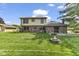Spacious backyard with a brick patio and fire pit surrounded by a lush green lawn at 5325 Ridge Hill Way, Avon, IN 46123