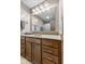 Bathroom features a large vanity, wood cabinets, framed mirror, neutral countertop, and ample storage at 5325 Ridge Hill Way, Avon, IN 46123