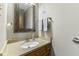 This is a powder room that features a traditional vanity with granite counters and a decorative framed mirror at 5325 Ridge Hill Way, Avon, IN 46123