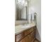 This is a powder room that features a traditional vanity with granite counters and a decorative framed mirror at 5325 Ridge Hill Way, Avon, IN 46123