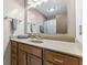 Bathroom features a large vanity, wood cabinets, a framed mirror, and neutral countertop at 5325 Ridge Hill Way, Avon, IN 46123