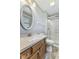 Bright bathroom features a walk-in shower, granite countertop, decorative mirror, and wood-look vinyl flooring at 5325 Ridge Hill Way, Avon, IN 46123