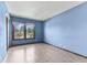 Light blue bedroom features vinyl wood floors, neutral trim, natural light, and leafy outdoor views at 5325 Ridge Hill Way, Avon, IN 46123
