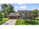 Two story home with brick and tan siding, long driveway, manicured lawn and mature landscaping at 5325 Ridge Hill Way, Avon, IN 46123
