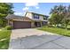 Charming two-story home featuring a brick and vinyl exterior, lush landscaping, and an attached two-car garage at 5325 Ridge Hill Way, Avon, IN 46123