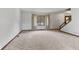 Bright living room with large window, neutral carpet, and a staircase leading to the upper level at 5325 Ridge Hill Way, Avon, IN 46123