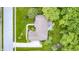 Bird's eye view of the tan roof of a house with a deck, and the surrounding green trees and yard at 5404 Cayman Dr, Carmel, IN 46033