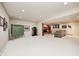 Finished basement featuring a fireplace, ping pong table, and comfortable seating area for entertainment at 5404 Cayman Dr, Carmel, IN 46033