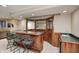 Finished basement wet bar with barstool seating, mirrored wall, and wood paneling at 5404 Cayman Dr, Carmel, IN 46033