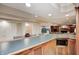 Basement wet bar area with wood cabinetry, recessed lighting, and seating at 5404 Cayman Dr, Carmel, IN 46033