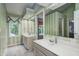 Bright bathroom with double sinks and a large mirror, featuring a decorative wallpaper at 5404 Cayman Dr, Carmel, IN 46033