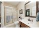 Well-lit bathroom featuring a shower with glass doors and a classic vanity with a dark wood finish at 5404 Cayman Dr, Carmel, IN 46033