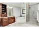 A bathroom features a glass enclosed shower, soaking tub under a window, and custom vanity at 5404 Cayman Dr, Carmel, IN 46033