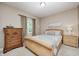 Cozy bedroom with woven bed frame, wood dresser, and natural light at 5404 Cayman Dr, Carmel, IN 46033